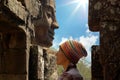 Face of woman on the background of the Stone head Royalty Free Stock Photo