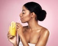 Face of woman, orange juice and drink in studio, pink background and detox for healthy skincare. African model, citrus Royalty Free Stock Photo