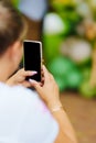 without a face. A woman takes a photo of a photo zone at a party. Royalty Free Stock Photo