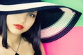 Face of young beautiful brunette in hat