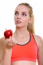 Face of young beautiful teenage girl holding red apple while thi Royalty Free Stock Photo