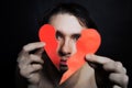 Face of young handsome man with broken paper heart Royalty Free Stock Photo