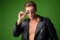 Face of young handsome rebellious man wearing leather jacket and sunglasses Royalty Free Stock Photo