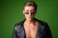 Face of young handsome rebellious man wearing leather jacket and sunglasses Royalty Free Stock Photo