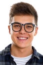 Face of young happy man smiling with eyeglasses