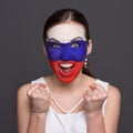 Young woman with Russian flag painted on her face Royalty Free Stock Photo