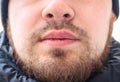 Face of a young man with messy and untrimmed beard and moustache close-up. Selective focus