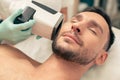 Man having eyes closed during the skin analysis procedure