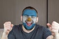 Face of young screaming  man painted with flag of Argentina.  Soccer team fan. Royalty Free Stock Photo