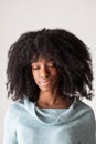 Face of a young smiling African girl with closed eye and afro hairstyle Royalty Free Stock Photo