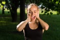 The face of a young sports girl close up with her mouth open. The concept of shout outdoors Royalty Free Stock Photo