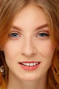 Face of young woman with blue eyes and red lips. Beauty portrait, fresh skin. Natural makeup