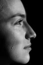 Face of young woman with tear drop close up