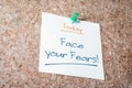 Face Your Fears Reminder For Today On Paper Pinned On Cork Board