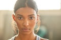 Face your fitness goals dead in the eye. Portrait of a fit young woman working out in a gym. Royalty Free Stock Photo