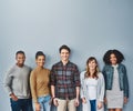 The face of the youth. Studio portrait of a diverse group of young people standing together against a gray background. Royalty Free Stock Photo