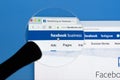 Facebook business homepage website on Apple iMac monitor screen under magnifying glass. Facebook is the most popular social Royalty Free Stock Photo