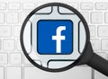 Facebook icon under the magnifying glass