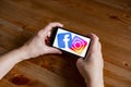 Facebook and instagram logo sign application screen on mobile phone online retail service, hands on Royalty Free Stock Photo