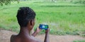 Facebook logo displaying on smart phone screen at village area by indian farmers holded