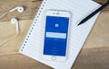 Facebook screen on smartphone with office supplies Royalty Free Stock Photo