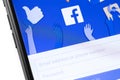 Facebook start page on the display smartphone. Facebook is largest and most popular social-media networking site in the world.