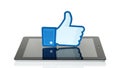 Facebook thumbs up sign printed on paper and placed on iPad on white background