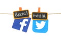 Facebook and Twitter logos, hangind on a rope