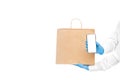 Faceless delivery man hold in hands brown paper eco friendly package.