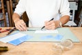 Faceless female entrepreneur cutting glass in artisan workroom. Business woman draws line