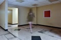 Faceless female walking through empty office space Royalty Free Stock Photo