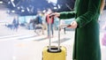 Faceless girl in green coat holds passport with ticket and yellow suitcase airport. Airplane travel concept in autumn Royalty Free Stock Photo