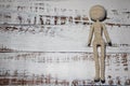 Faceless knitted human figure on wooden background