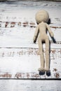 Faceless knitted human figure on wooden background