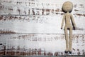 Faceless knitted human figure on wooden background