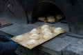 faceless man puts a tray of cheesecakes into the oven. Small family bakery. concept of local products. blurred Royalty Free Stock Photo