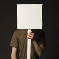Faceless person holding a blank sign