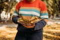 Faceless plus size woman with book and maple leaves in fall autumn park in sun lights. Body positive, diversity, Body