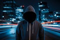 Faceless thief in hoodie standing at night in front of city Royalty Free Stock Photo