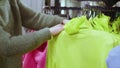 Faceless woman is shopping in clothing store