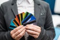 A faceless woman in a suit holds several multi-colored credit cards. A bank employee shows a lot of different plastic Royalty Free Stock Photo