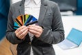 A faceless woman in a suit holds several multi-colored credit cards. A bank employee shows a lot of different plastic Royalty Free Stock Photo