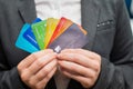 A faceless woman in a suit holds several multi-colored credit cards. A bank employee shows a lot of different plastic Royalty Free Stock Photo