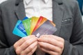 A faceless woman in a suit holds several multi-colored credit cards. A bank employee shows a lot of different plastic Royalty Free Stock Photo