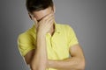 Facepalm. The man shows the emotion of disappointment. In a yellow t-shirt on a gray background