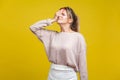 Facepalm. Portrait of regretful young woman with fair hair in casual beige blouse, isolated on yellow background