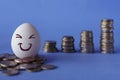 Faces on the eggs, investment concept. Happy investor smiling in front of his growing money Royalty Free Stock Photo