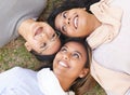 Faces, group and women lying on the ground in a park for cheerful bonding with love and care. Friendship, overhead and