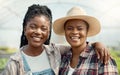 Faces of happy farm workers. Portrait of smiling colleagues in a greenhouse. African american farmers working in Royalty Free Stock Photo