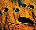 Faces in the sand